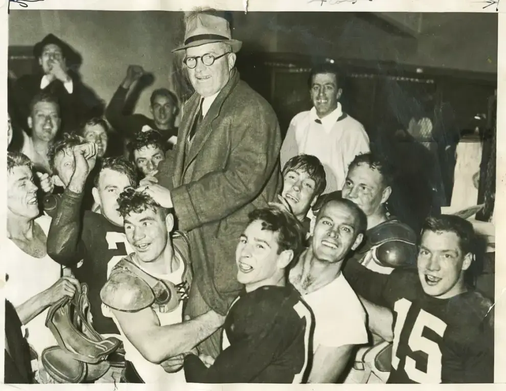 Coach E. L. (Curly) Lambeau (second from left) and his staff plan