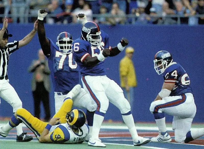 A dejected Lawrence Taylor of the New York Giants sits in front of