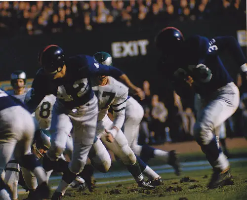 New York Giants quarterback Charley Conerly (42) is chased by