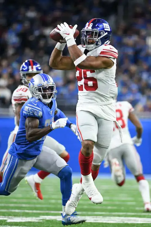 DETROIT, MI - NOVEMBER 26: Detroit Lions running back Kerryon Johnson (33)  runs through a hole in