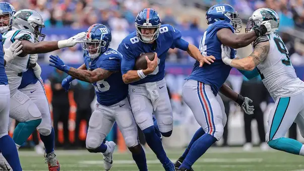 New York Giants outside linebacker Azeez Ojulari (51) and New York Giants  defensive end Leonard Williams (99) react against the Carolina Panthers  during an NFL football game, Sunday, Oct. 24, 2021, in