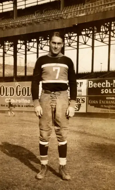 Red Grange kicking as Carl Brumbaugh holds - quarterback for